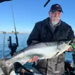 Returning client holding a king Salmon caught off 50 Point, Lake Ontario