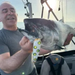 Angler holding a King Salmon caught near Niagara Bar aboard Fishin’ Finatics Charters